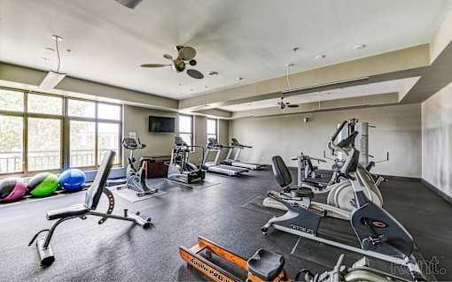 A spacious home gym with a variety of exercise equipment.