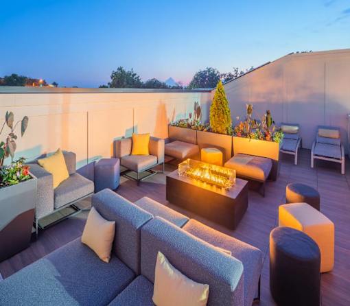 Silver Spring, MD Apartments Near Brookside Nature Center - Atelier Apartments - Modern Outdoor Seating Area Featuring A Lit Fire Pit