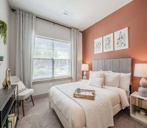 Silver Spring, MD Apartments Near Matthew Henson State Park - Atelier Apartments - Bedroom Featuring Plush Carpeting, Large Windows With Curtains, And High Ceilings
