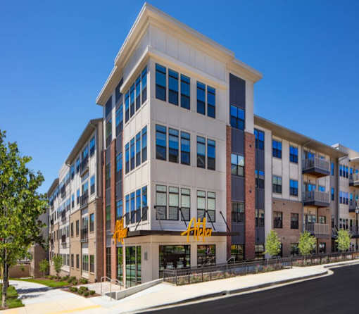 A modern multi-story building with a mix of brick and glass windows.