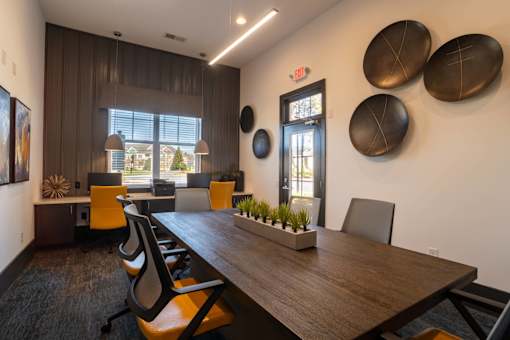 A conference room with a long table and chairs.