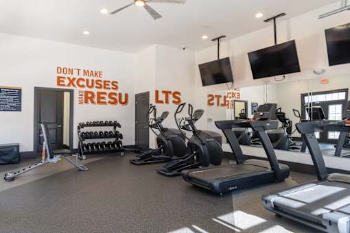 A gym with a sign that says "Don't make excuses when you're in the gym.".