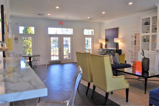 A living room with a yellow chair and a black table.