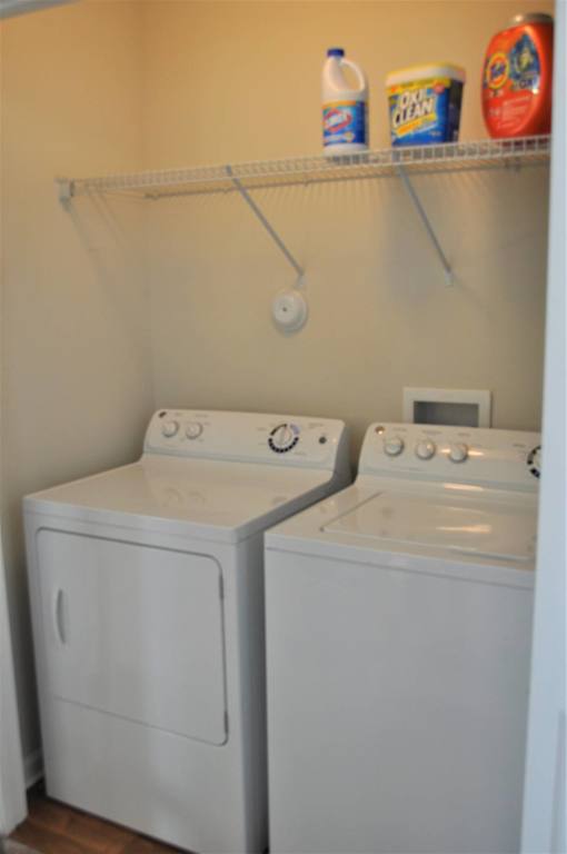 A small laundry room with a washer and dryer.