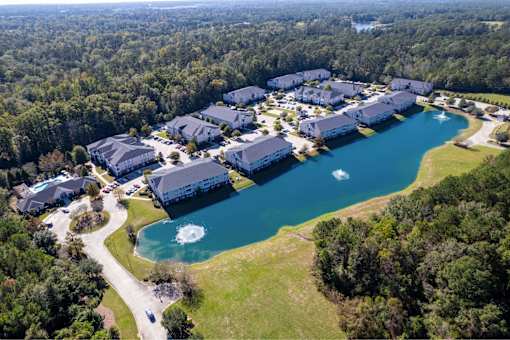 A bird's eye view of a resort with a large lake and buildings.