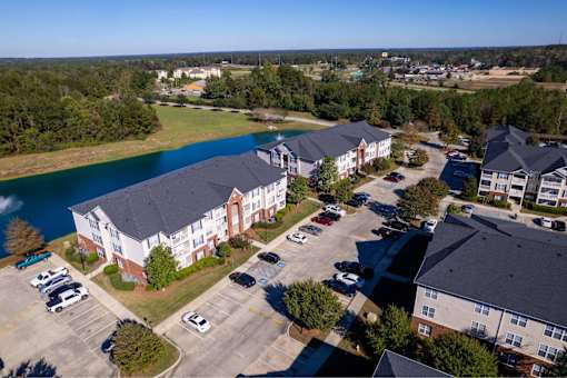 A large building with a parking lot in front of it.