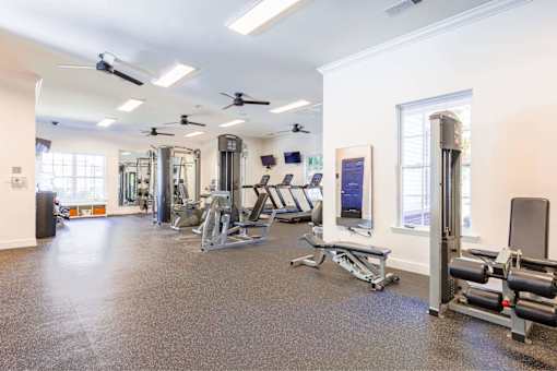 A spacious gym with a variety of equipment including treadmills, weights, and exercise machines.