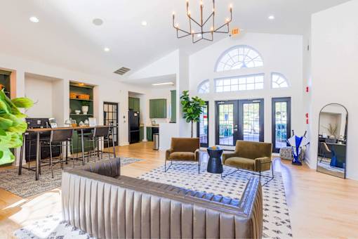 A large, modern living room with a long sofa and a coffee table.