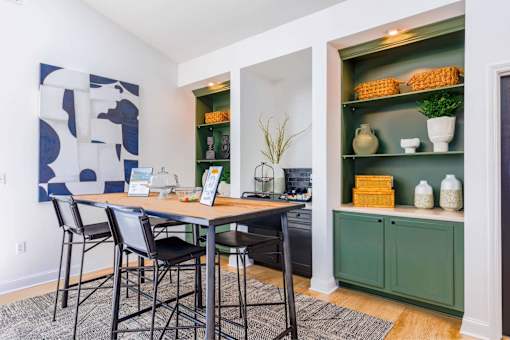 A dining room with a table and chairs.