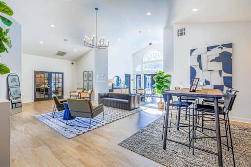 A modern living room with a blue and white rug on the floor.