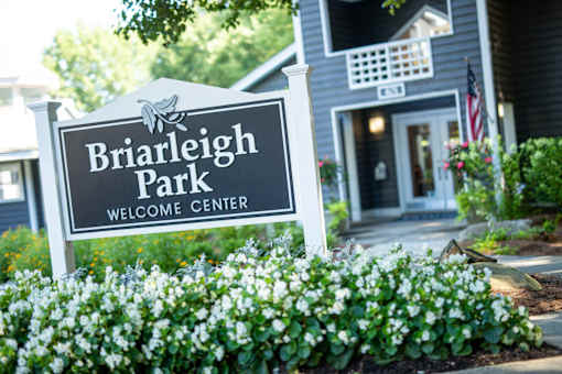 A sign that says Briarleigh Park Welcome Center in front of a house.
