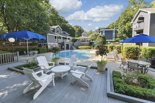 A backyard with a pool and deck.