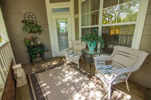 A sunny patio with a table and chairs.