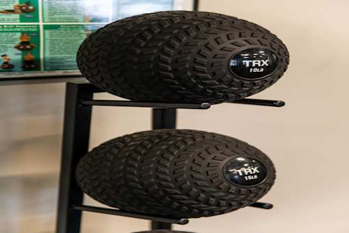Two black TRX tires are displayed on a stand.