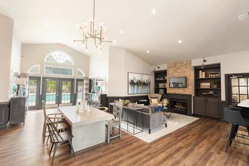 A modern open concept living room with a dining area and kitchen.