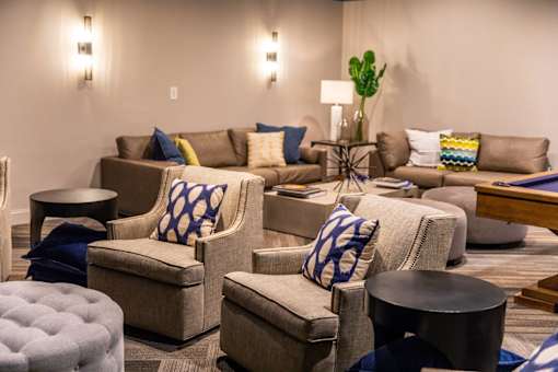 A living room with a brown couch and blue and yellow pillows.