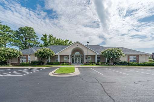 A building with a parking lot in front of it.
