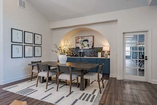 A dining room with a table set for four.