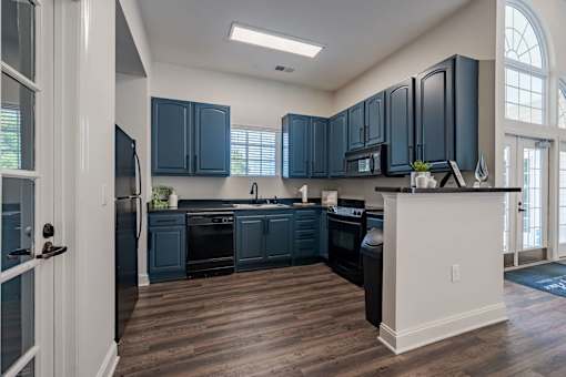 A kitchen with dark blue cabinets and a white island.
