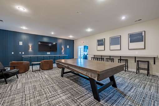 A conference room with a long table and chairs.