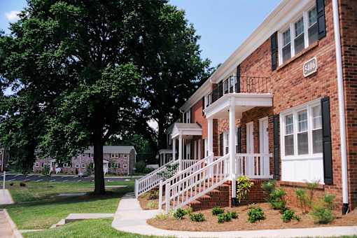A tree is in front of a house.