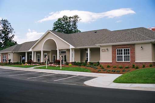 A building with a parking lot in front of it.