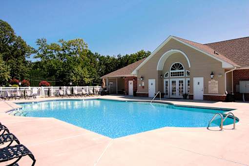 A pool with a building behind it.