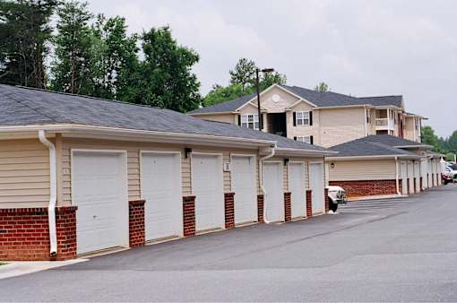 A long row of garage doors in front of houses.