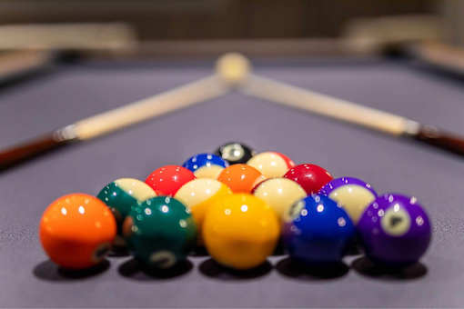 A pool table with a variety of colored balls.