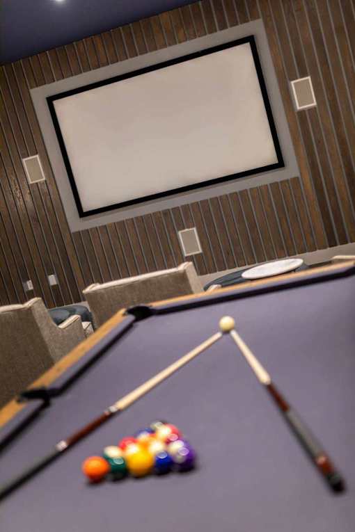 A pool table with a cue stick and balls.