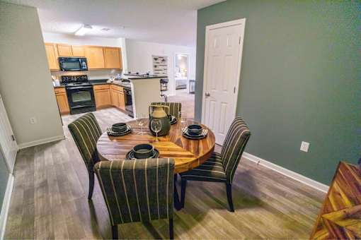 A dining room with a table set for four.