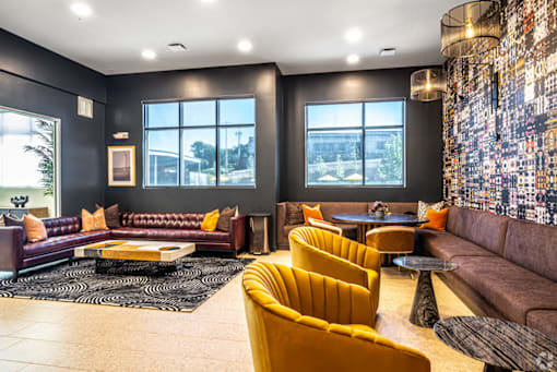 A living room with a black wall and a large window.