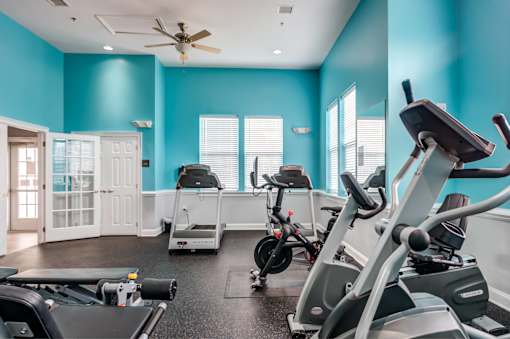 A spacious gym with a variety of exercise equipment.