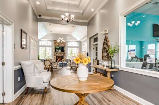 A living room with a fireplace and a dining table.