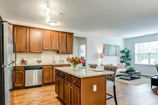A kitchen with wooden cabinets and a refrigerator.