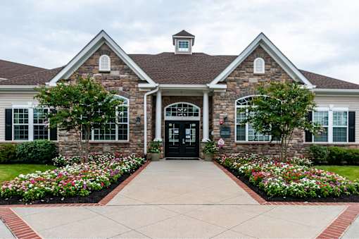 A house with a black front door and a brick facade.
