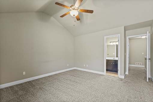 A room with a ceiling fan and carpeted floor.