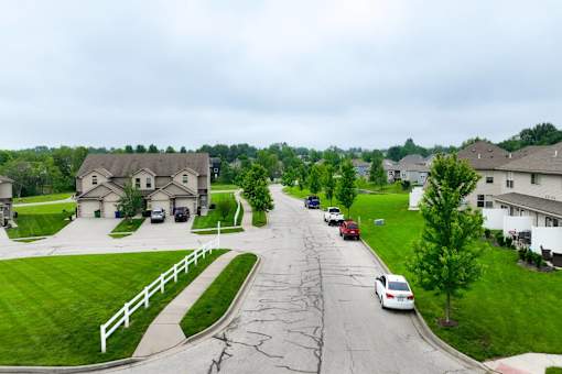 A residential street with cars parked on the side.