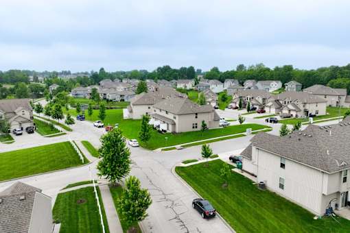 A residential area with houses and cars.