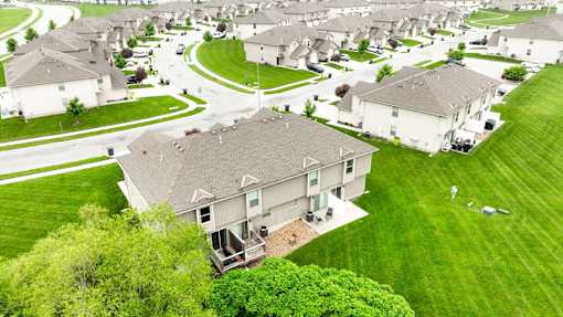 A residential area with houses and green lawns.