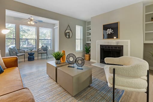 A living room with a fireplace and a chair.