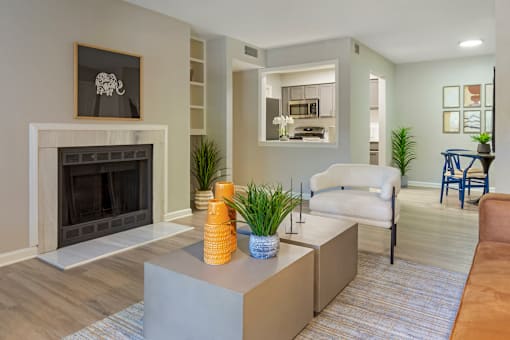 A living room with a fireplace and a grey sofa.