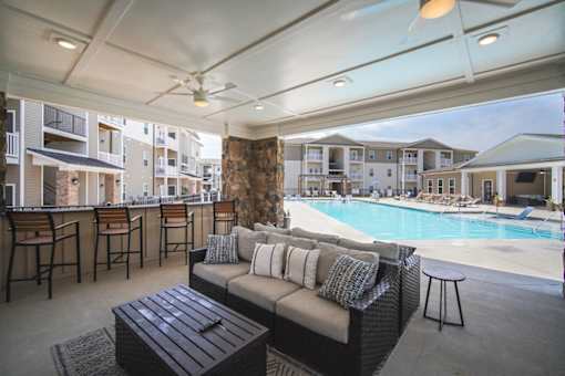 A patio with a pool and a couch.