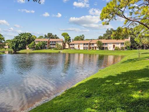 A serene lakeside view with a building in the background.