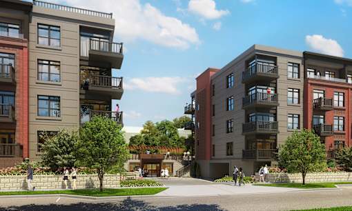 A modern apartment complex with balconies and multiple stories.