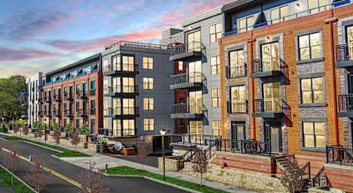 A street view of a row of modern apartment buildings.