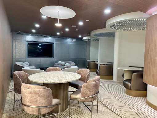 A modern dining room with a round table and chairs.