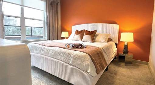 A bedroom with a large bed and a window.