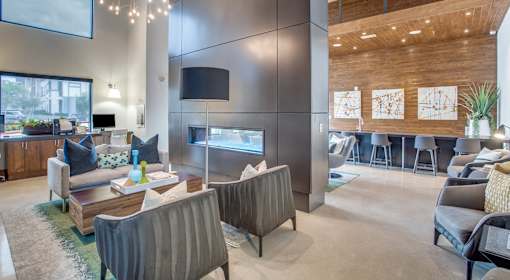 A modern living room with a television and comfortable seating.