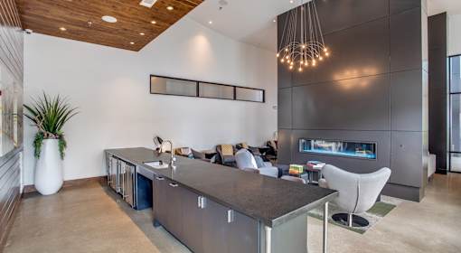A modern kitchen with a wooden ceiling and a large island.